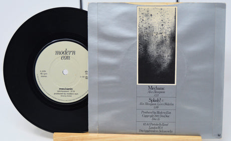 Vinyl record with a silver sleeve on a white background