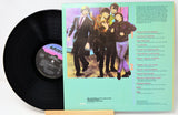 Vinyl record with cover featuring a band and text on a white background
