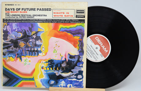 A vinyl record album shown with its printed cover in front and the black record partially visible behind it on a light gray background. The cover reads 'Days of Future Passed with The Moody Blues' and 'Nights in White Satin,' with Deram branding visible on the label and top right corner.