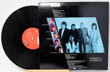 Vinyl record with cover featuring a group of people on a white background