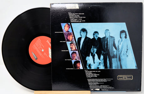 Vinyl record with cover featuring a group of people on a white background