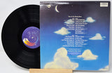 Vinyl record with a blue cover featuring clouds and text