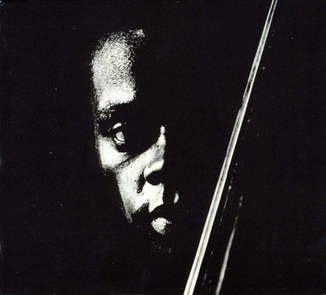 Dramatic black and white close-up portrait of a musician with intense shadows and a vertical line.