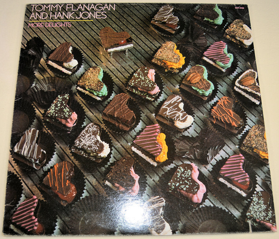 Front cover of More Delights album with heart-shaped chocolates and artist names