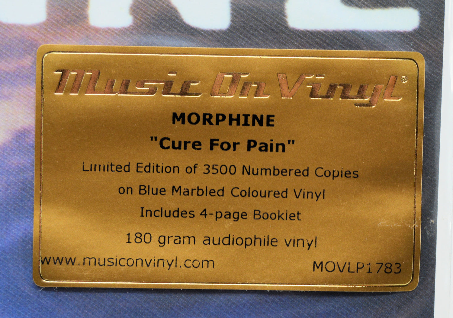 A gold-colored metal label for Music On Vinyl's 'Morphine - Cure For Pain' limited edition vinyl record, detailing the 3500 numbered copies on blue marbled colored vinyl.