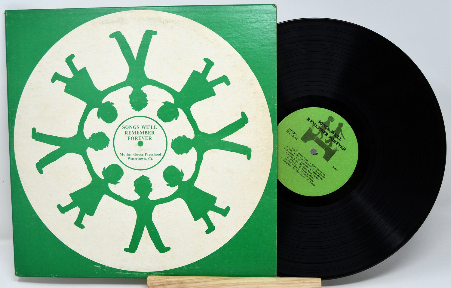 Front cover of Songs We'll Remember Forever vinyl album with green child silhouettes