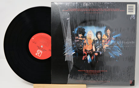 Vinyl record with a colorful cover featuring band members on a white background