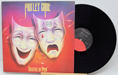 Vinyl record with 'Theatre of Pain' by Motley Crue on a white background