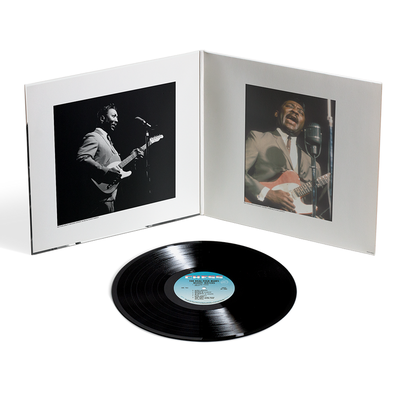 Vinyl record with a white cover featuring black and white photos of musicians playing guitar.