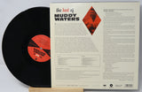Vinyl record with cover displaying 'The Best of Muddy Waters' on a light gray background