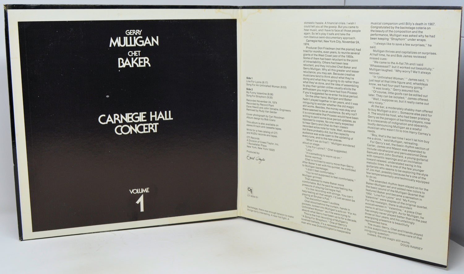 An open book or program booklet showing the front cover on the left with a black background and white text reading 'Gerry Mulligan and Bart Baker Carnegie Hall Concert Volume 1,' and printed text pages on the right.
