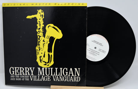 Vinyl record with a yellow saxophone illustration and text about Gerry Mulligan and the Village Vanguard.