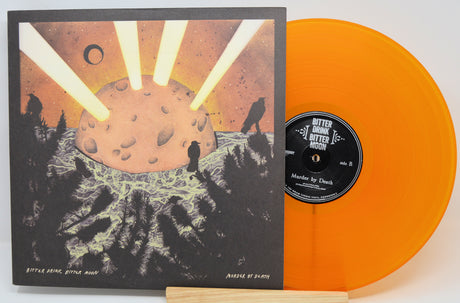 A vinyl record album shown with its illustrated outer sleeve and a translucent orange record partially visible behind it on a white background.