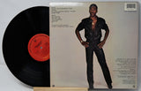 Vinyl record with a person on the cover and a red label