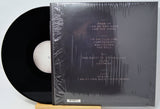 Vinyl record with a black cover on a white background