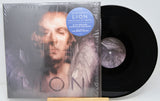 Vinyl record with cover featuring a person's face and album title 'LION'.