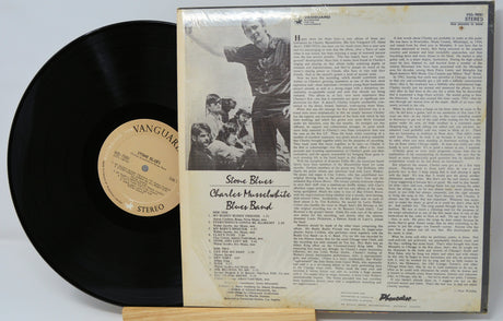 Vinyl record with a black cover and white text on a light gray background