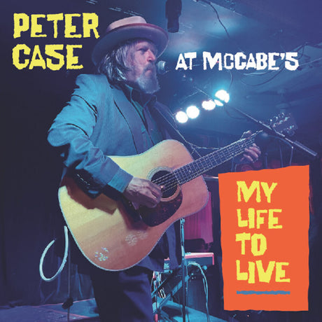 Man playing guitar on stage with text 'Peter Case at McCabe's My Life to Live' on a dark background