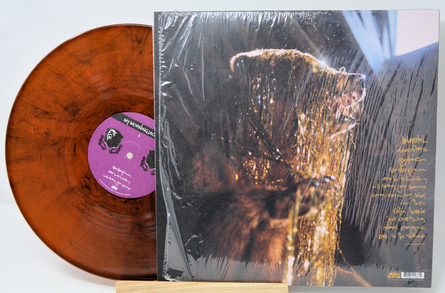 Vinyl record with a brown disc and a cover featuring an image of a bear covered in gold foil.