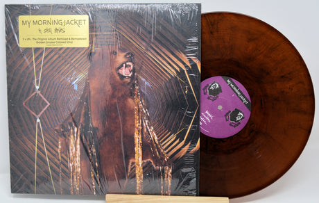 Vinyl record with cover featuring a bear and a purple label on a white background