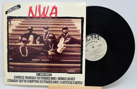 Vinyl Cover feature five men sitting on a benches with their feet up. 