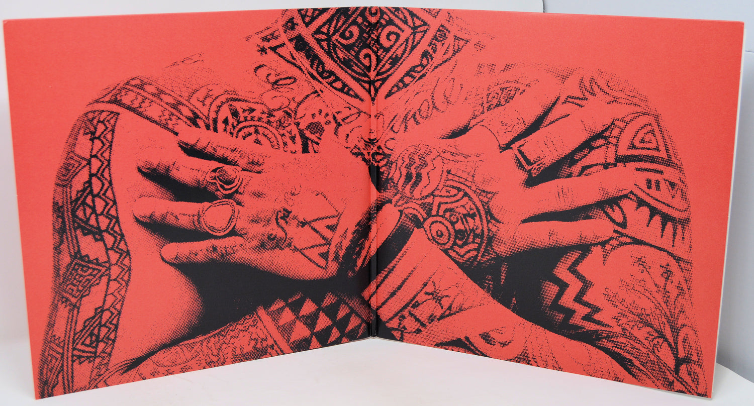 Book with tattooed hands design on a red background