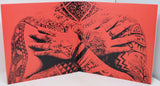 Book with tattooed hands design on a red background