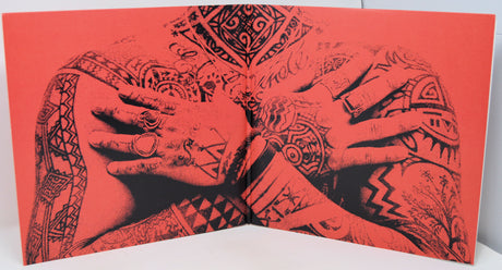 Book with tattooed hands design on a red background