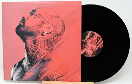 Vinyl record with a cover featuring a tattooed person on a red background