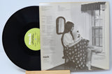 Back cover of Nanci Griffith's 'Poet in My Window' vinyl LP featuring tracklist and grayscale photo of Nanci by a window