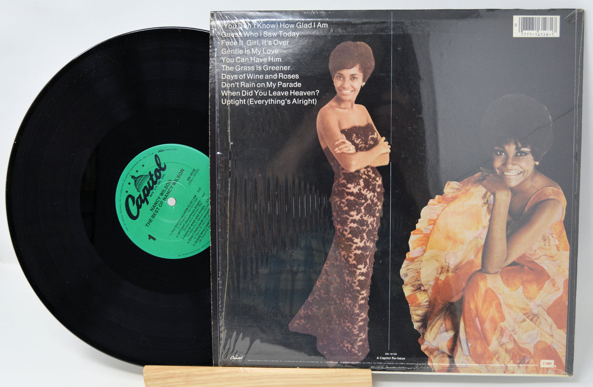 Vinyl record with a green label and cover featuring a woman in a dress.