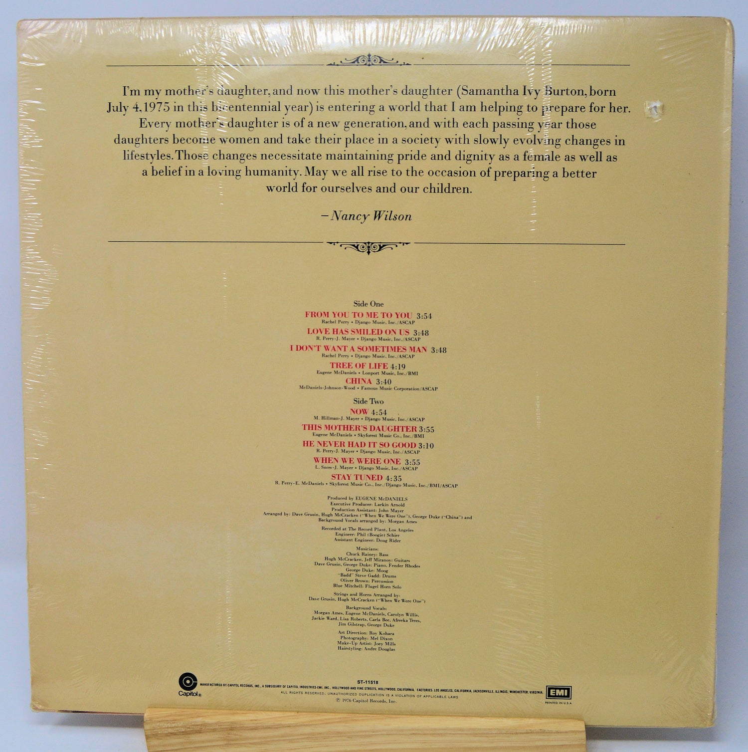Back cover of a vinyl record with text and tracklist on a beige background