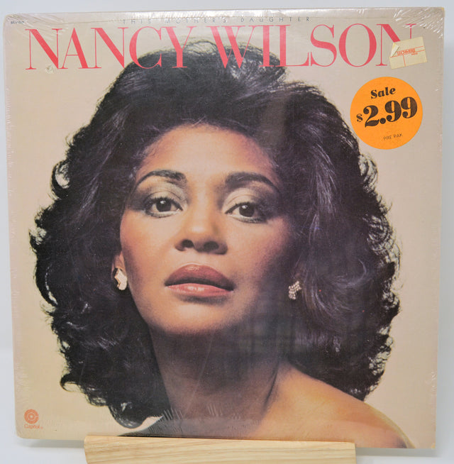 Album cover featuring a woman's face with 'Nancy Wilson' text and price tag.