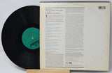 Vinyl record with its cover displaying text on a light gray background