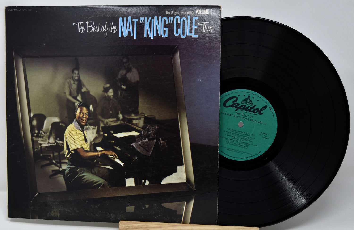 Vinyl record with cover featuring Nat King Cole on a white background
