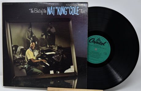 Vinyl record with cover featuring Nat King Cole on a white background