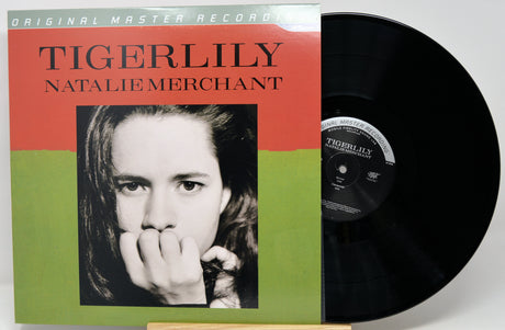 Tigerlily - Natalie Merchant original master record vinyl LP, showing the album cover with a portrait and the black vinyl record partially pulled out.