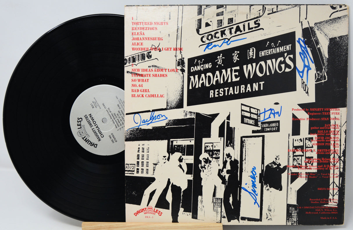 Vinyl record with a cover featuring black and white graphics and text, including 'Madame Wong's Restaurant'.