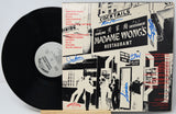 Vinyl record with a cover featuring black and white graphics and text, including 'Madame Wong's Restaurant'.