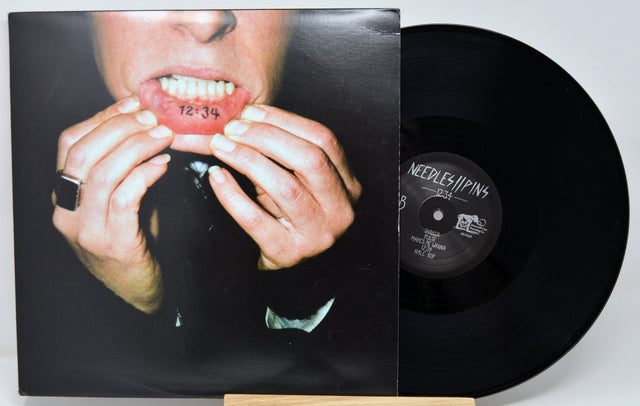 Vinyl record with a person holding their face on the cover