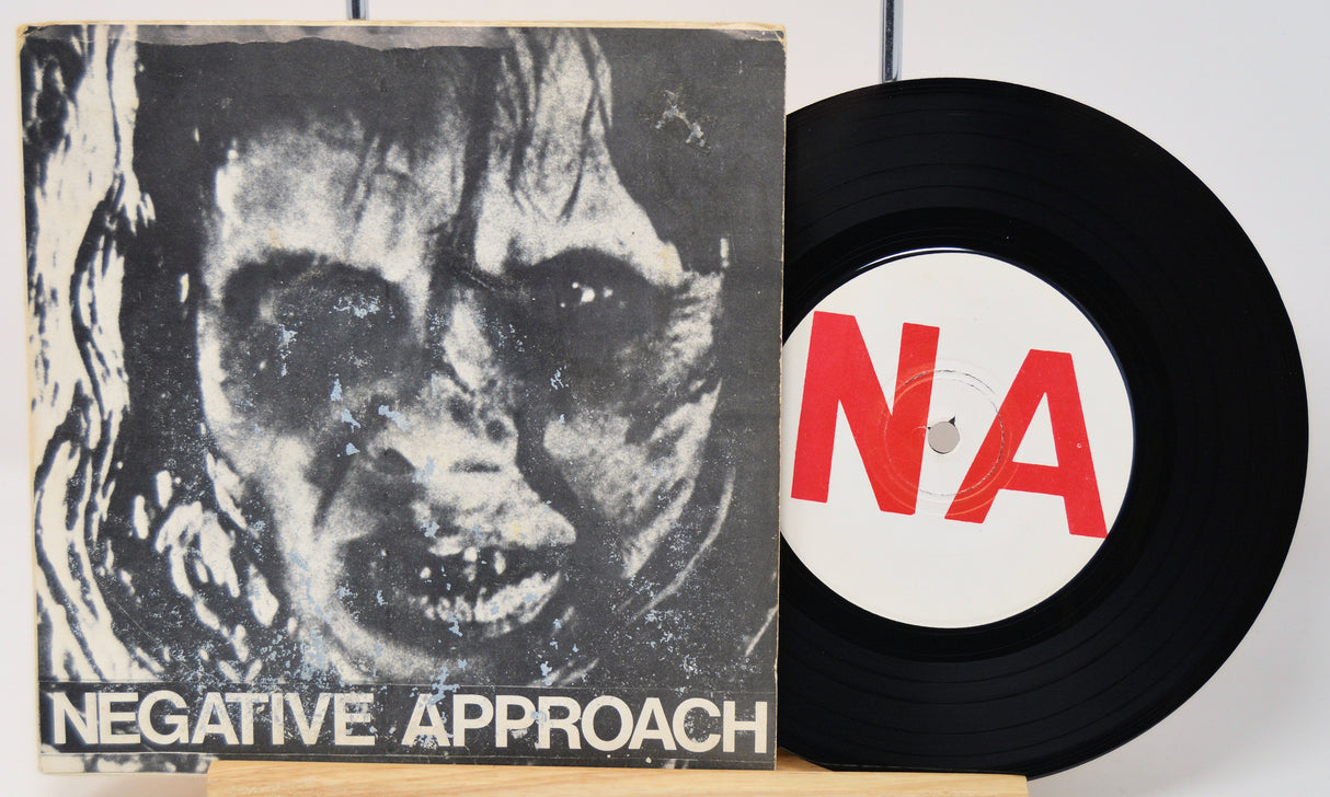 Vinyl record with 'Negative Approach' album cover featuring a black and white image of a face.