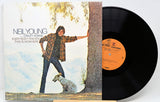 Neil Young's 'Crazy Horse' vinyl record LP with its illustrated cover jacket and the black record partially pulled out, showing the orange center label.