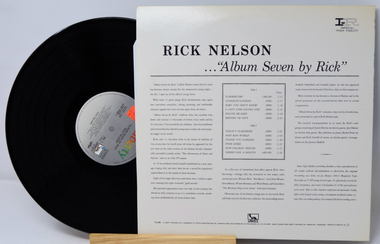 Vinyl record with its cover displaying 'Rick Nelson Album Seven by Rick' on a light gray background.