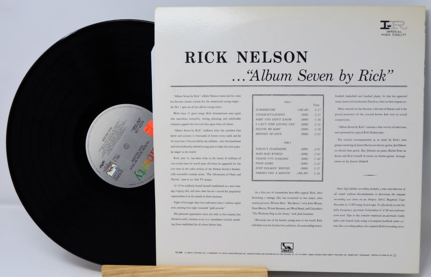 Vinyl record with its cover displaying 'Rick Nelson Album Seven by Rick' on a light gray background.
