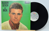 Vinyl record with green album cover featuring a person's portrait and 'Album Seven by Rick' text.