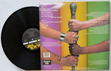 Vinyl record with colorful cover featuring two hands holding a bat.