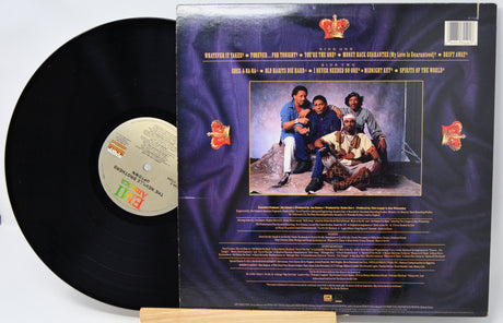 Vinyl record with cover featuring a group of people and text on a white background