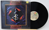 Vinyl record with cover featuring the Neville Brothers on a white background