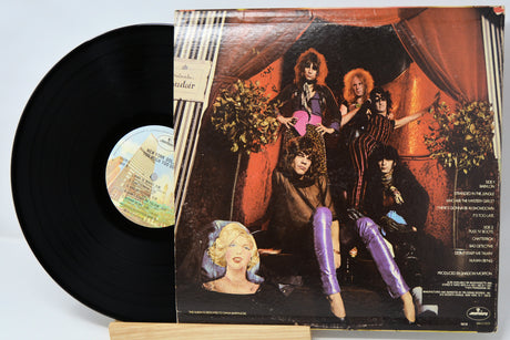 Vinyl record with a colorful cover featuring people and a woman's face.