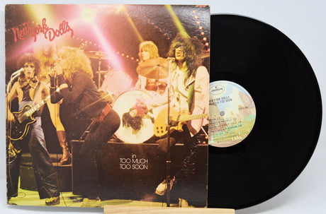 Vinyl record with a cover featuring a band and the title 'Too Tough Too Soon'.